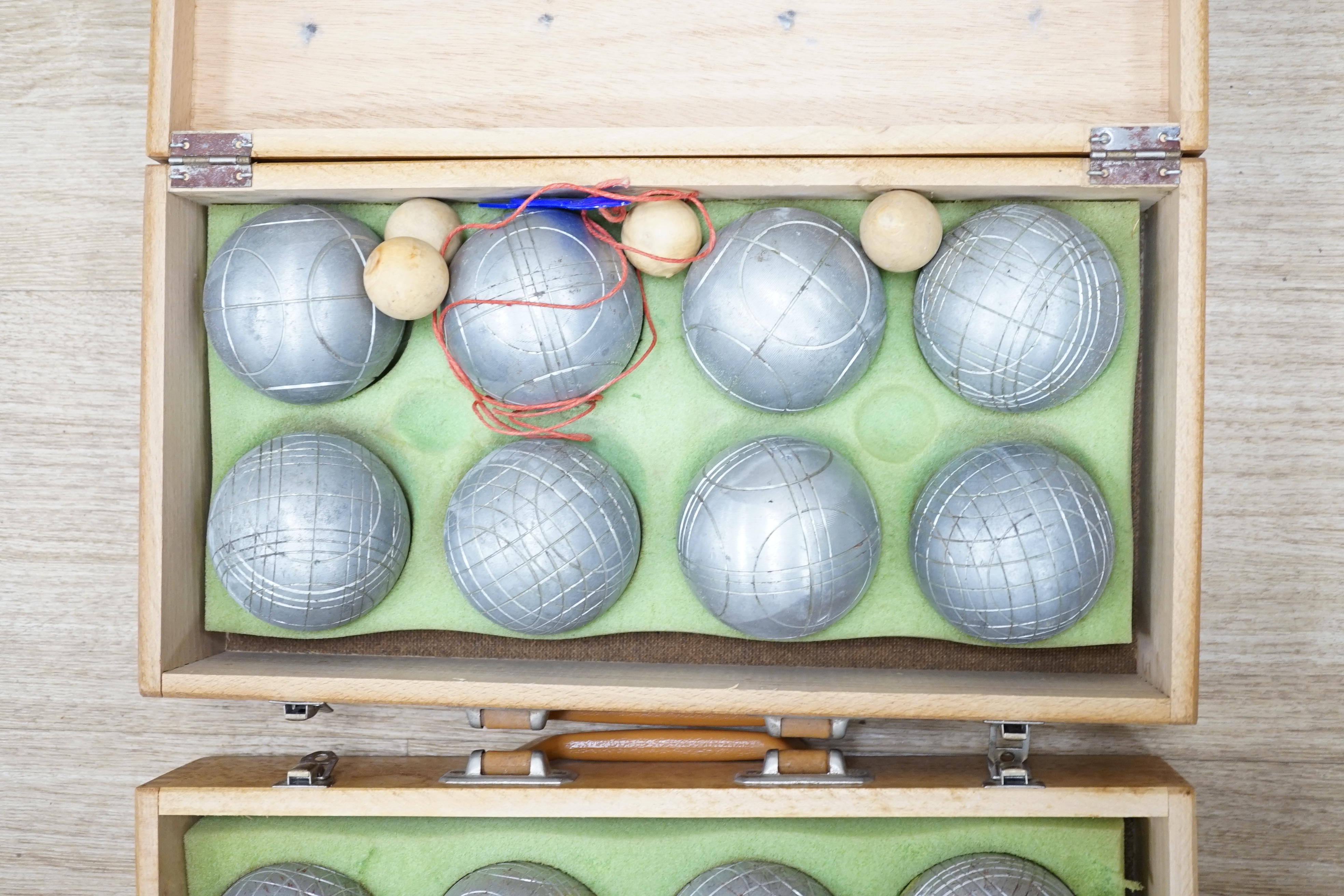 Two wooden-cased Petang sets